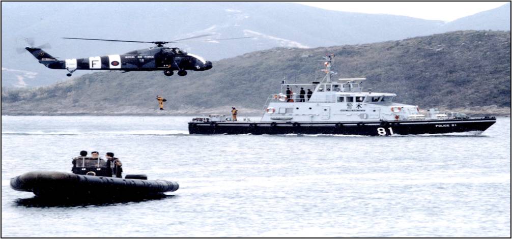 Police Launch 81 ‘King Mei’ DAMEN Mk III Class conducting a winching exercise with a Wessex helicopter of 28th Squadron Royal Air Force and a Small Boat Unit craft.