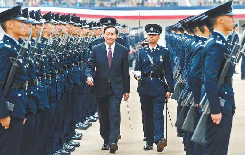 Mr Wong inspects the graduates at the passing-out parade