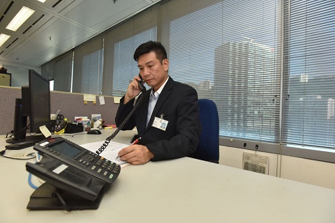 Photograph: Police officer answering the 24-hour complaint hotline