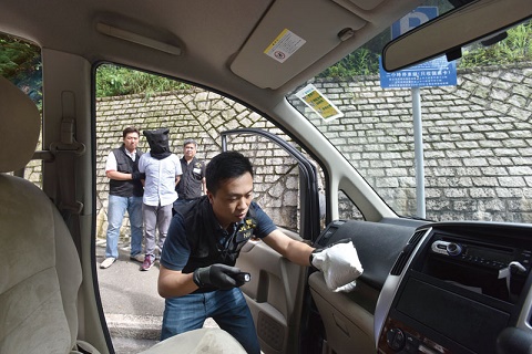 Photograph: Police officer of Narcotics Bureau gathering exhibits