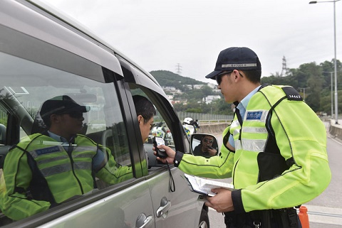 Photograph: Traffic Police officer conducting breath test on a driver