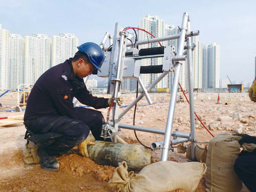 An Explosive Ordnance Disposal officer renders a 100-pound aircraft bomb safe
with the assistance of the Abrasive Water Cutting System.