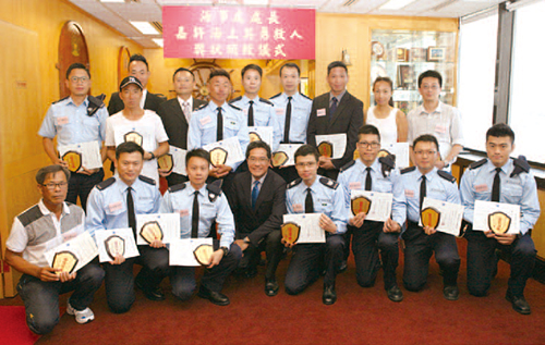 The Director of Marine, Mr Wong Wai-lun, commends nine Marine Police officers for saving lives at sea. 
