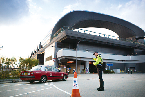 Traffic Kowloon East officer conducts traffic management outside the Kai Tak Cruise Terminal.