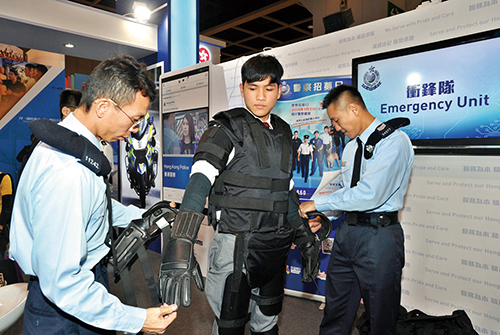 Emergency Unit officers introduce their work and equipment to a visitor at the Education and Careers Expo.