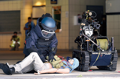 A Bomb Disposal Officer removing an explosive device in a counter terrorism exercise.