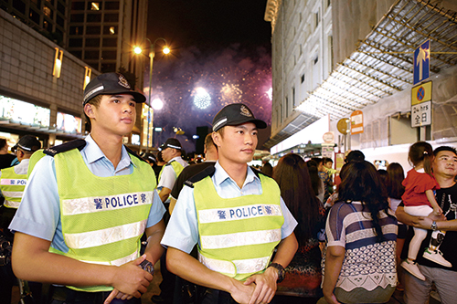 Auxiliary Police officers performing crowd management duties during a fireworks display. 