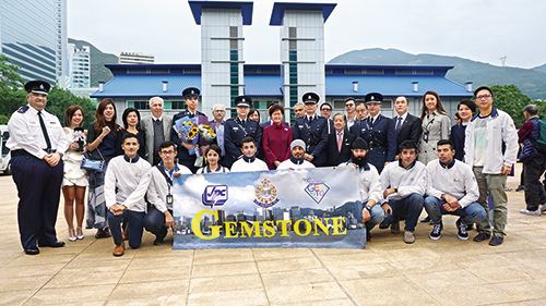 A new Police Inspector (back row, sixth from left) from Project Gemstone is welcomed by Chief Executive, Mrs Carrie Lam (back row, centre), senior Force members, and current members of Project GEMSTONE at the Police passing-out parade.