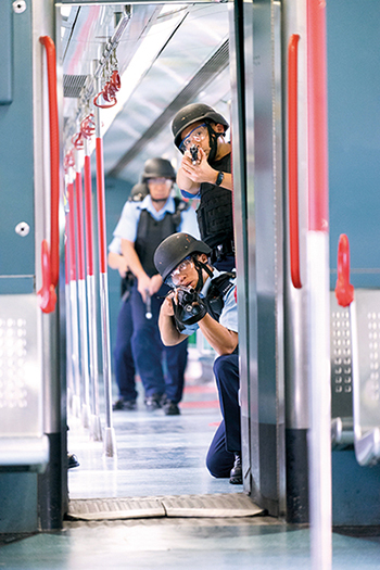 Emergency Unit New Territories South officers conducting an anti-terrorist attack exercise on an MTR train.