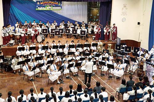 The Police Band in action with secondary school student musicians.