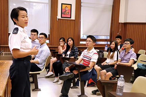 An officer delivering a recruitment talk to overseas students in Canada.
