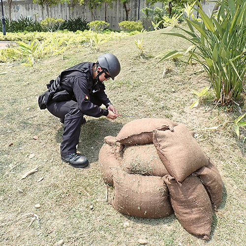 An officer of the Explosive Ordnance Disposal Bureau examined an unexploded bomb at Wu Shan Riverside Park in Tuen Mun in April.