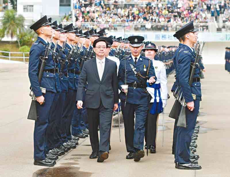 Mr John Lee inspects the graduates at the Police College
