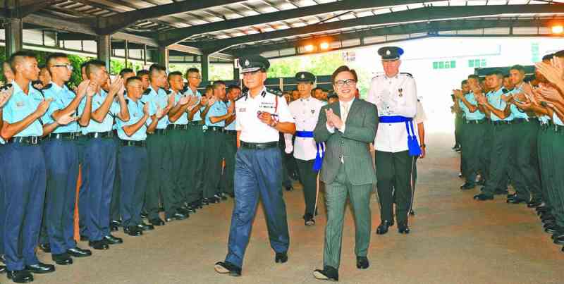 Mr Wong, accompanied by CP, meets the graduates after the passing-out parade